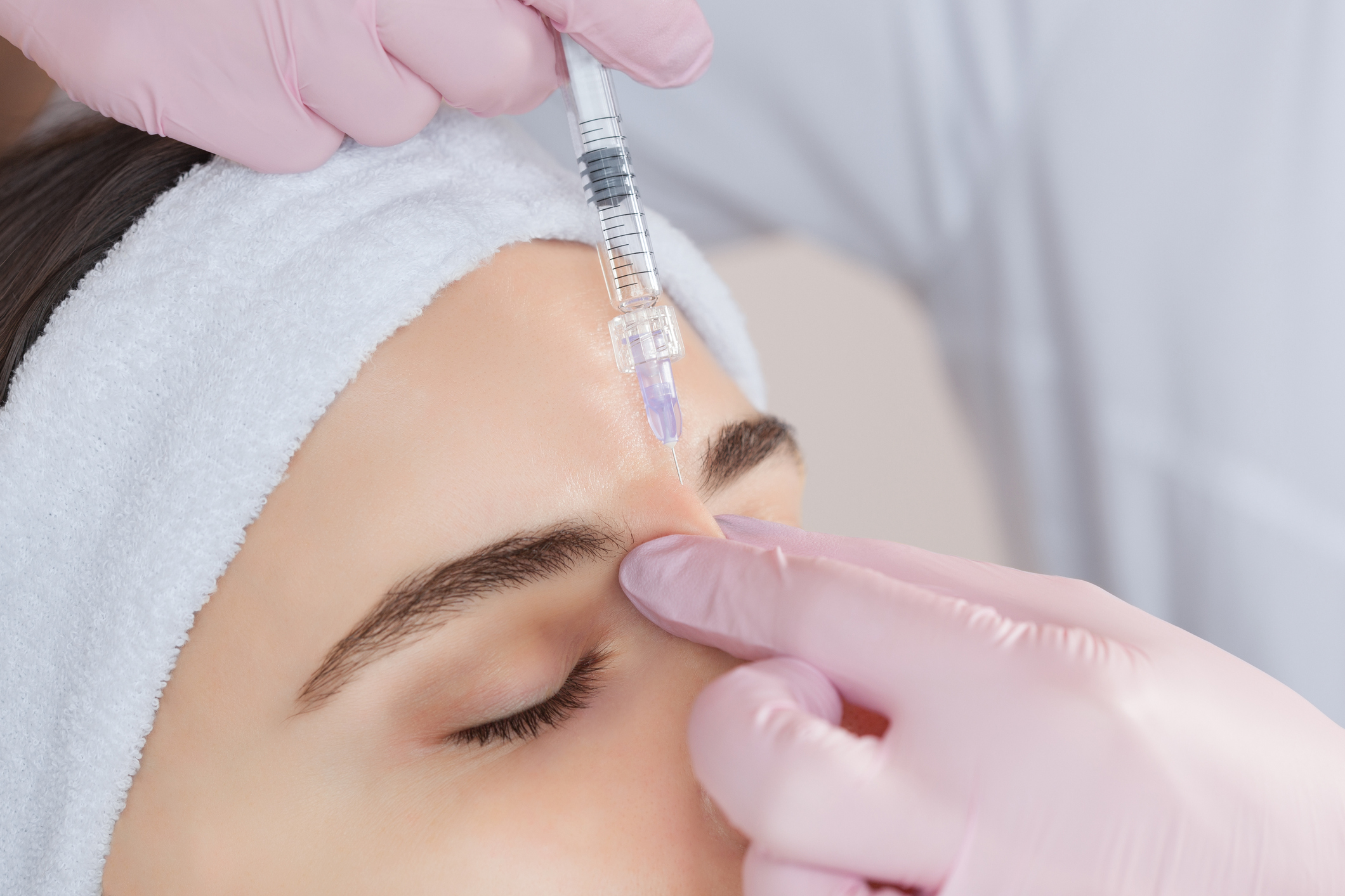 The doctor cosmetologist makes the Rejuvenating facial injections procedure for tightening and smoothing wrinkles on the face skin Botox Behandlungen in Wien